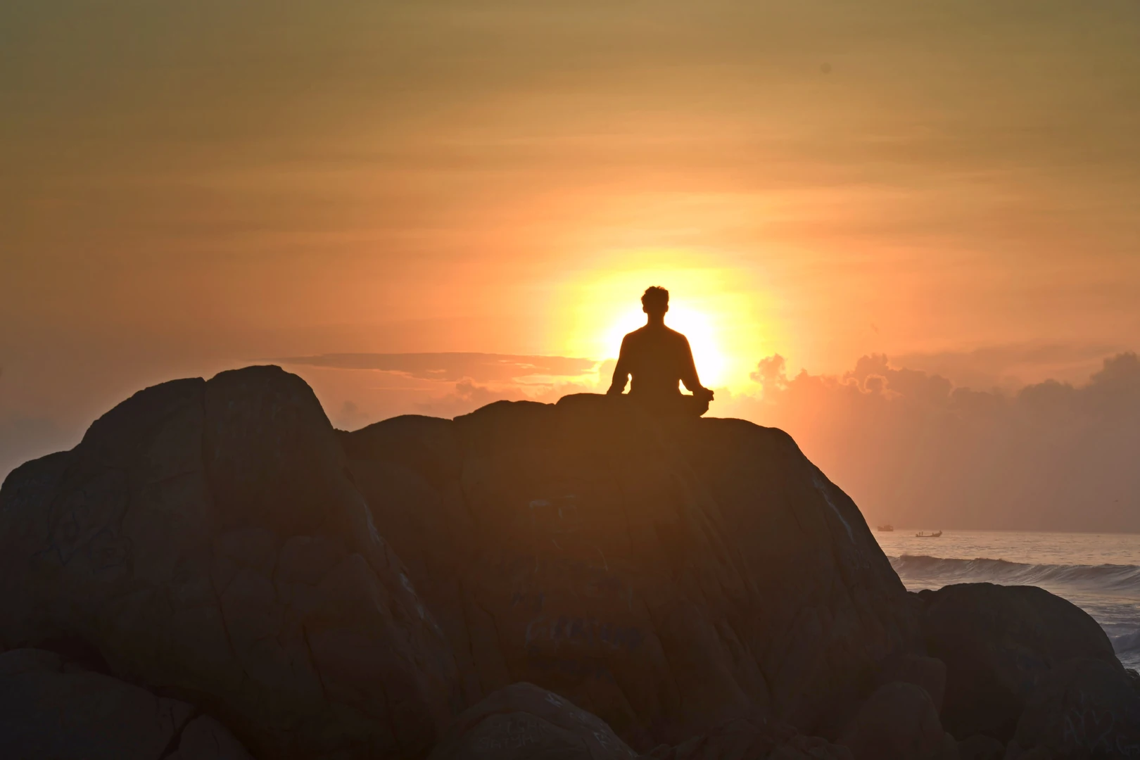Person sitting quietly outdoors at sunrise
